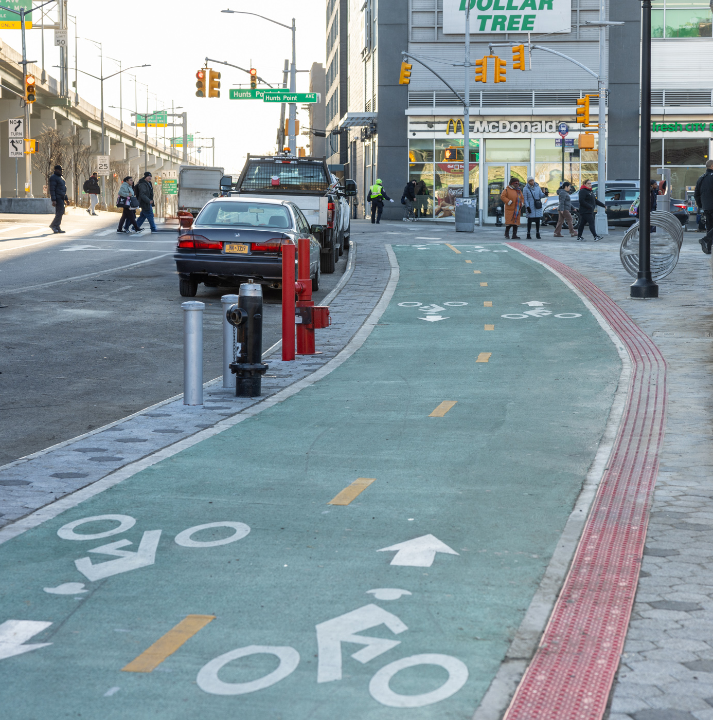 A two-way green bike lane connecting to a plaza next to Hunts Point Rd.