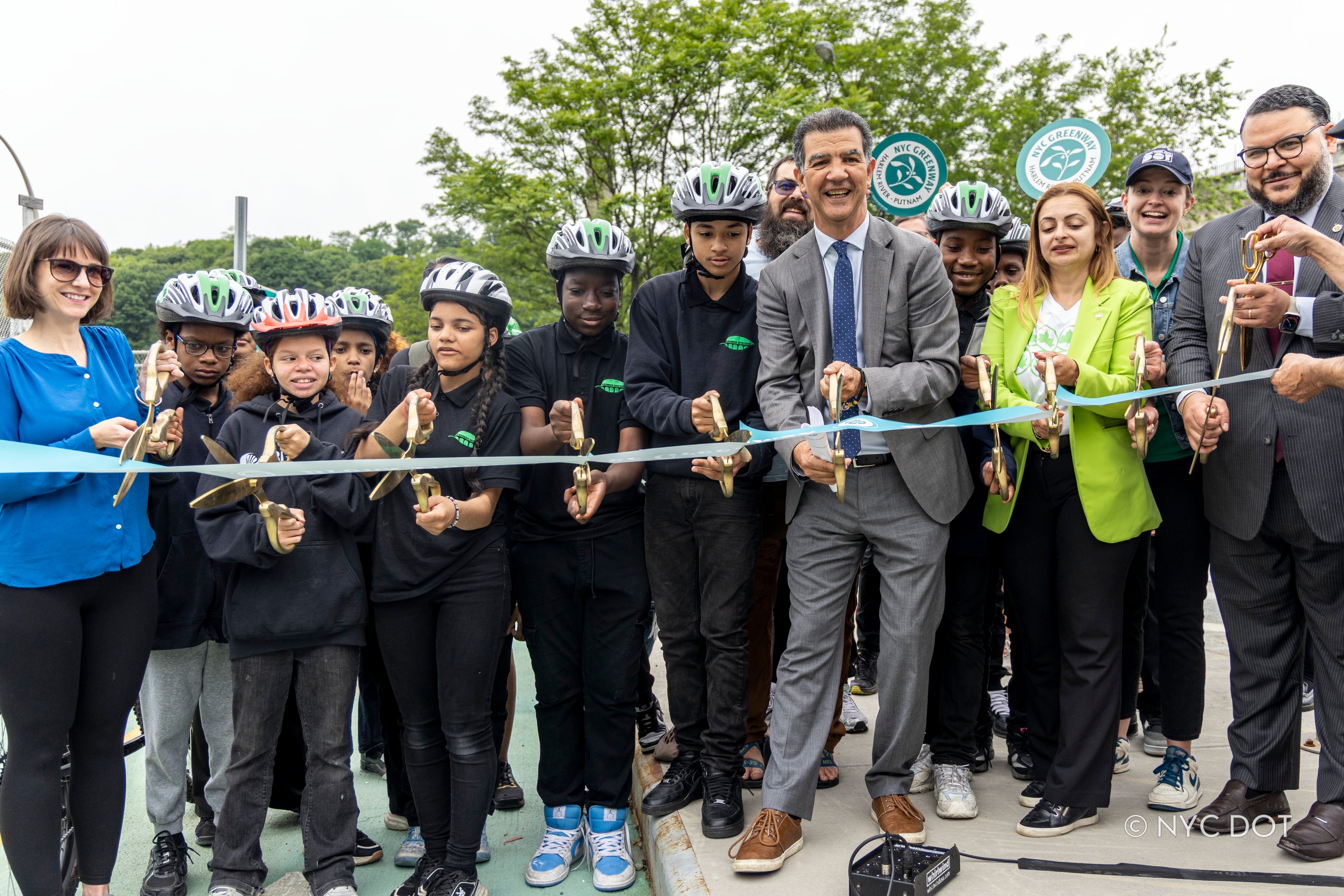 Commisioner Ydanis Rodríguez, joined by City employees and local schoolchildren, attend a ribbon cutting ceremony celebrating the launch of the Harlem River Greenway.