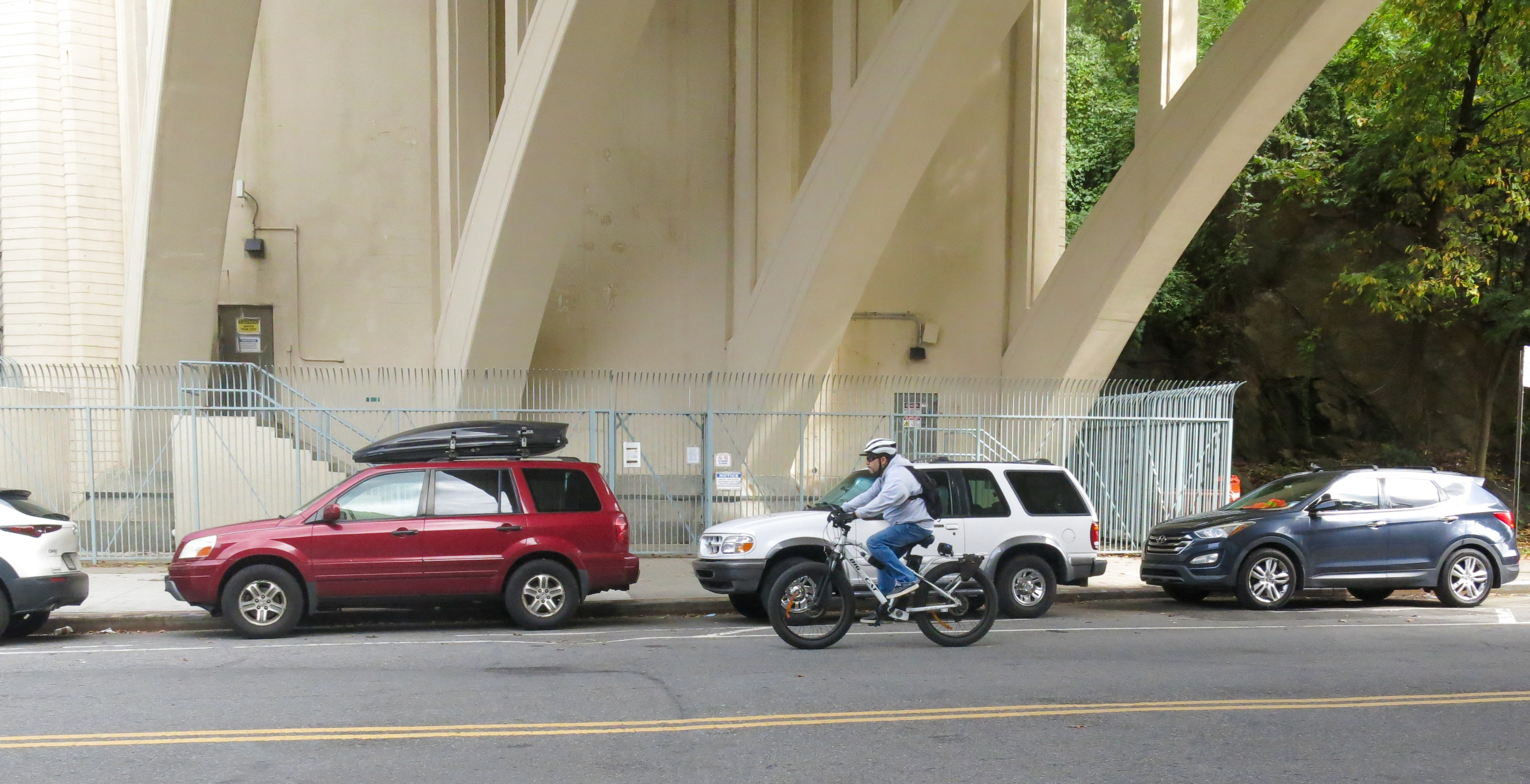 Cyclists rides beneath the 9-A underpass.