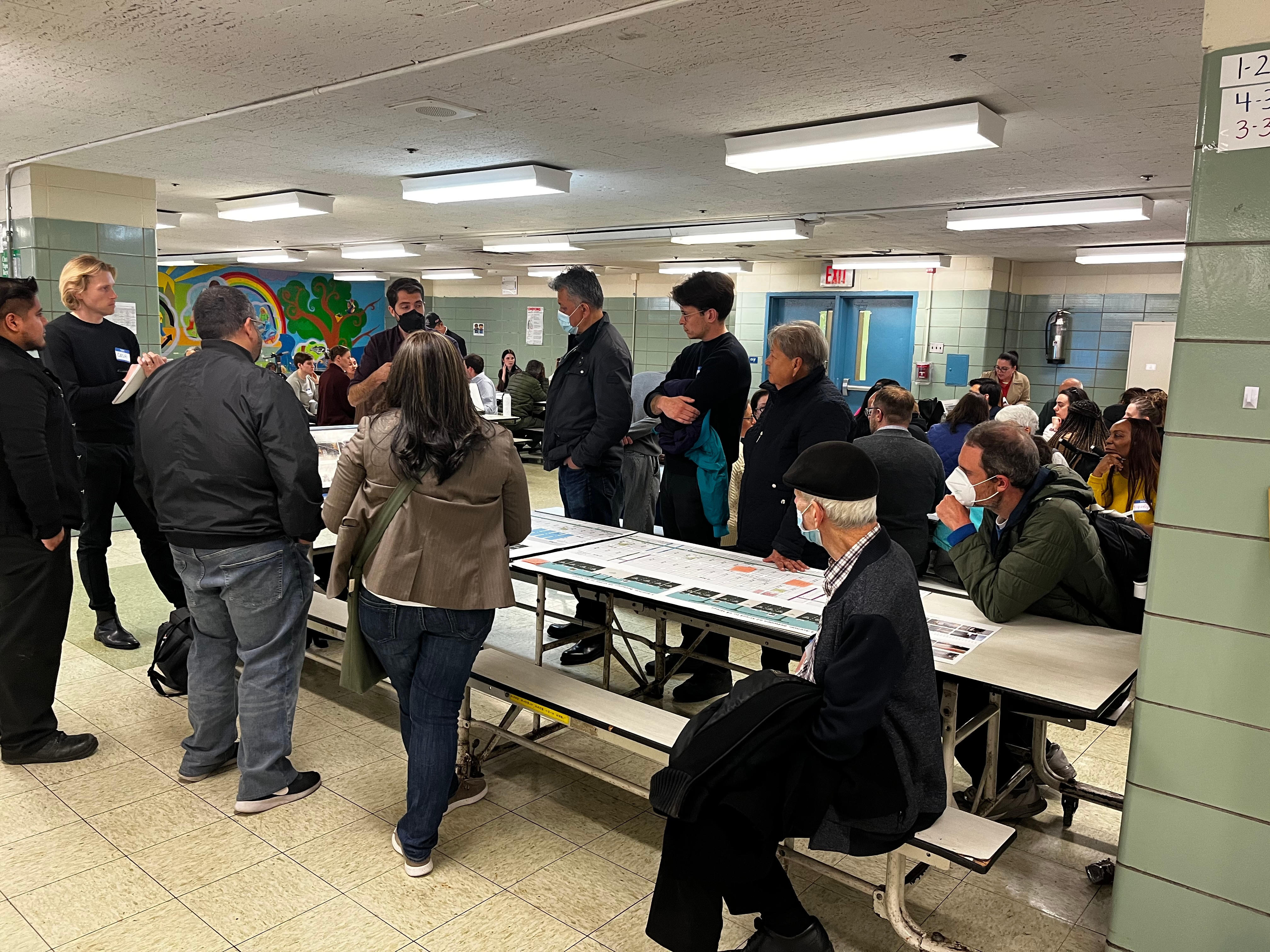 Community members gathered in school cafeteria around tables to discuss 3rd Avenue, Prospect Ave to 62nd St