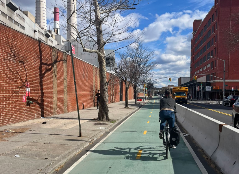 A person bikes in a two-way protected bike lane on Vernon Boulevard in Queens.