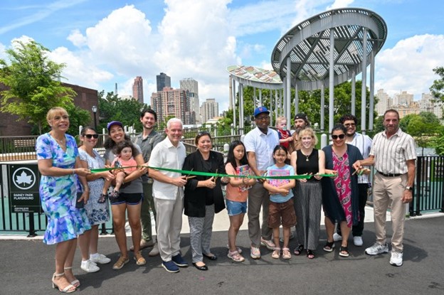 Group of people celebrating the reopening of Rainey Park