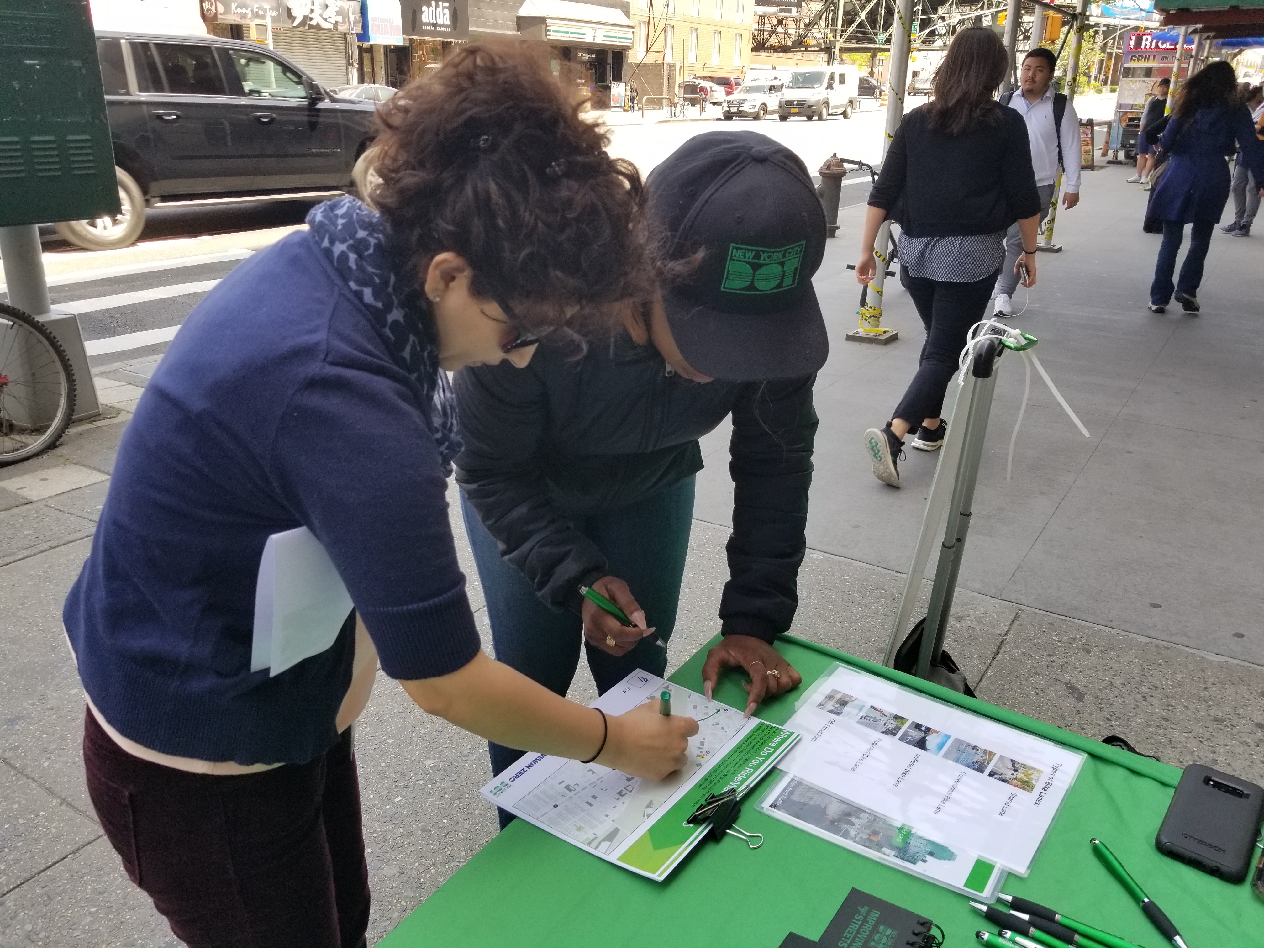 DOT Street Ambassador helping a resident participate in a mapping activity during outreach in 2019