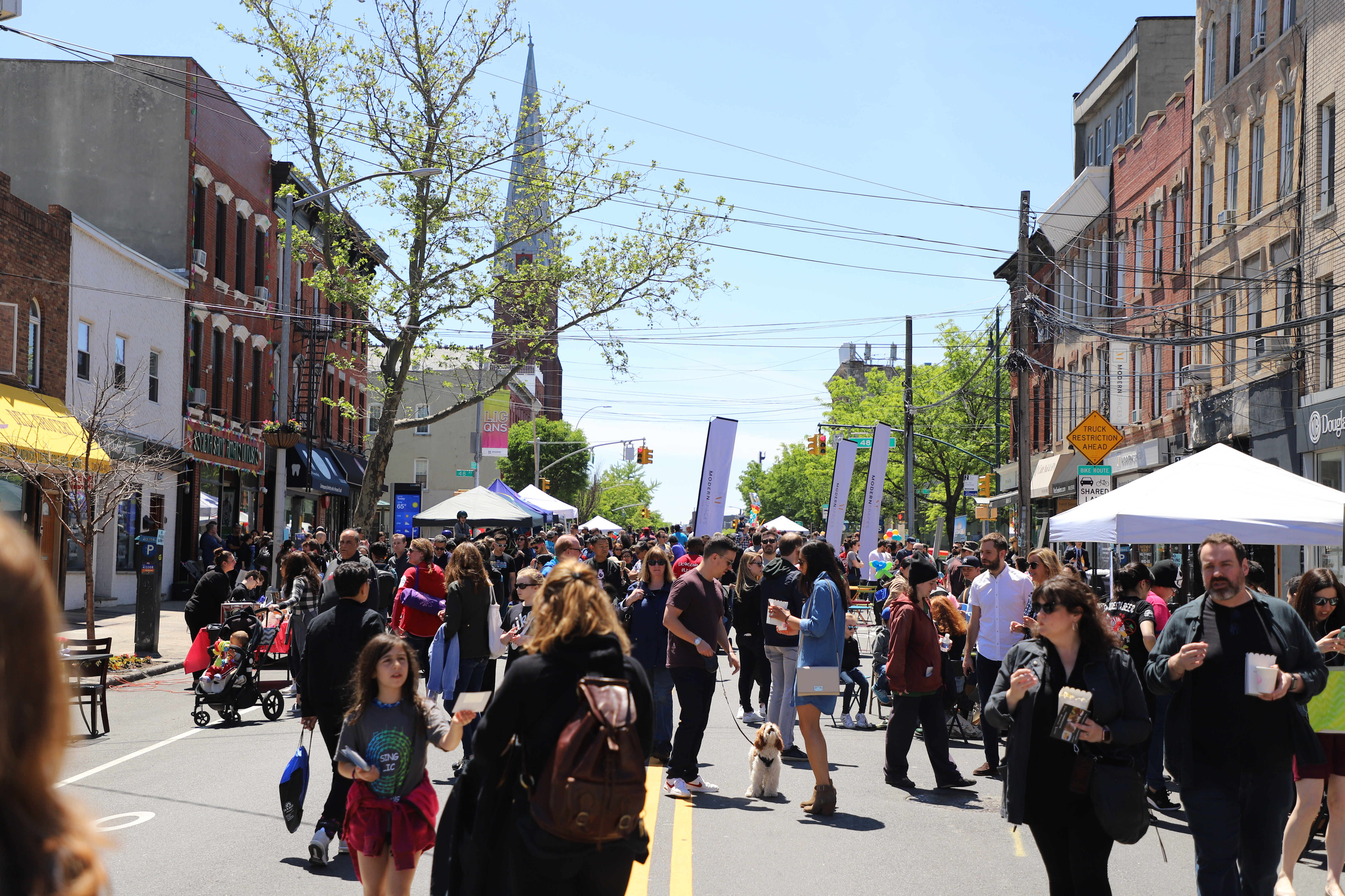 People gathered and tents set up for a Vernon Boulevard Weekend Walk in 2019.