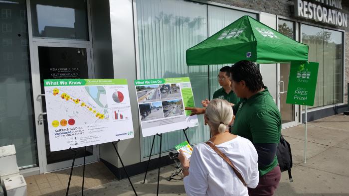 A DOT representative explaining the project to a resident of Forest Hills.