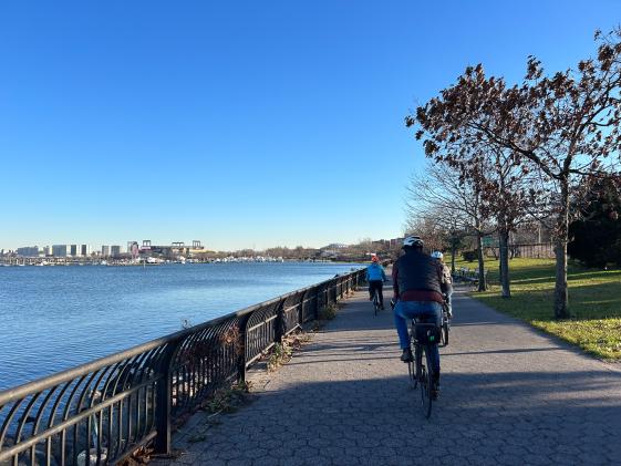 Image of cyclists riding along Malcolm X. Promenade.