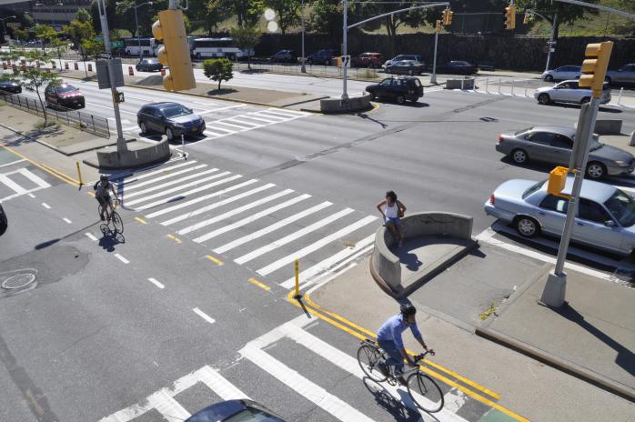 An aerial image of Queens Boulevard and 56th Street. Cyclists can be seen in the bike lane. 