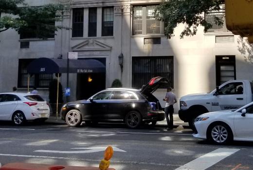person unloading their goods from a personal vehicle parked in a neighborhood loading zone in west end avenue, Manhattan