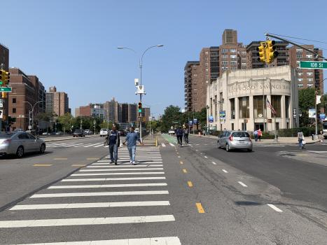 Pedestrians and cyclists at Queens Blvd and 71st Ave