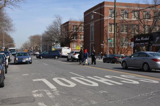 Pedestrians crossing Avenue X amidst traffic when the Avenue still featured wide traffic lanes..