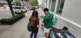 Survey participant and NYC DOT Street Ambassador taking a survey on public realm improvements in Long Island City