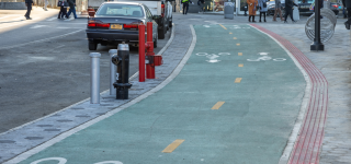 A two-way green bike lane connecting to a plaza next to Hunts Point Rd.