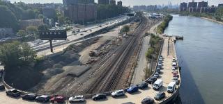 Aerial shot capturing cars parked along Depot Place bridge.