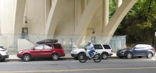 Cyclists rides beneath the 9-A underpass.