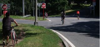 Three cyclists enter Van Cortlandt Park.