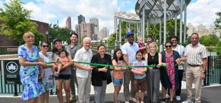 Group of people celebrating the reopening of Rainey Park